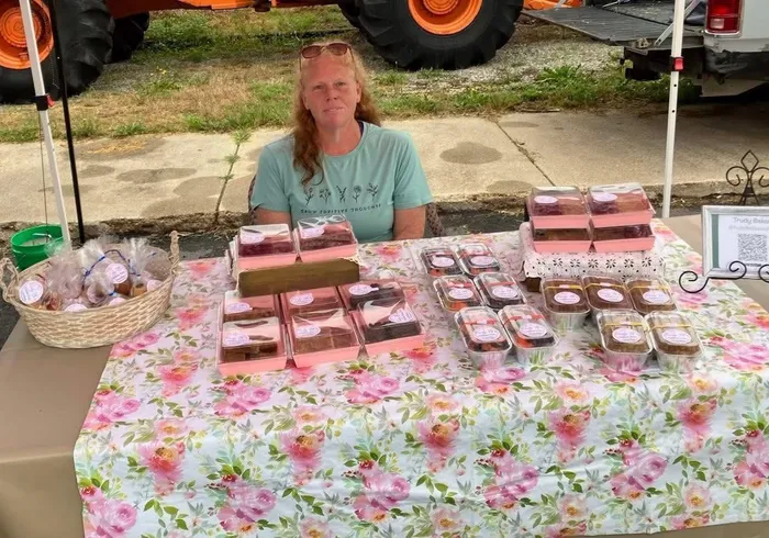 Trudy Baker behind her market table of gluten-free goodies